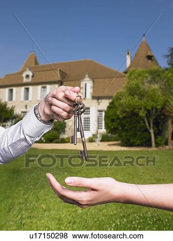 Woman receiving keys to country home View Large Photo Image Stock Photo - Woman receiving keys to country home. Fotosearch