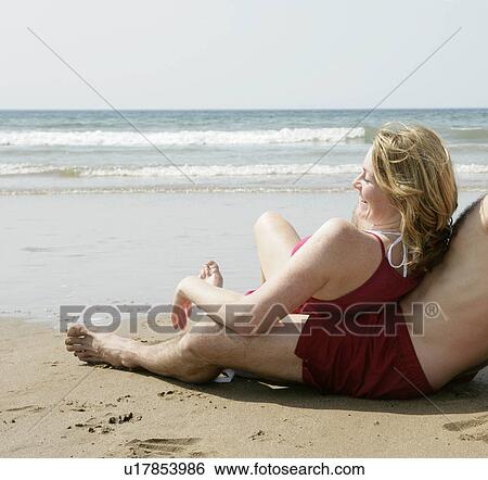 woman relaxing by beach View Large Photo Image Stock Photograph - woman relaxing by beach. Fotosearch