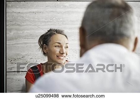 Woman smiling, man shot from behind View Large Photo Image Stock Photo - Woman smiling, man shot from behind. Fotosearch