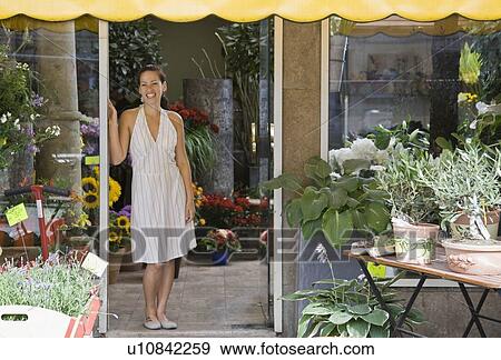 Woman standing in a flower shop View Large Photo Image Stock Photo - Woman standing in a flower shop. Fotosearch