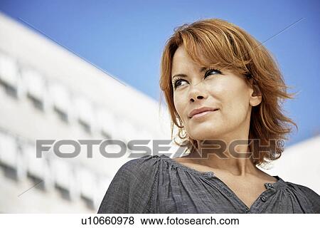 Woman standing in front of buildings View Large Photo Image Stock Photo - Woman standing in front of buildings. Fotosearch