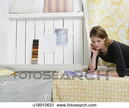 Stock Image - Woman studying plans. Fotosearch