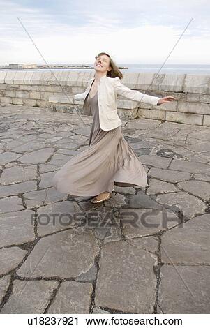 woman twirling skirt outside View Large Photo Image Stock Image - woman twirling skirt outside. Fotosearch