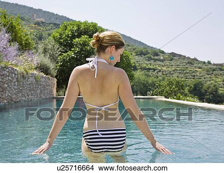 Woman wading in the pool View Large Photo Image Picture - Woman wading in the pool. Fotosearch