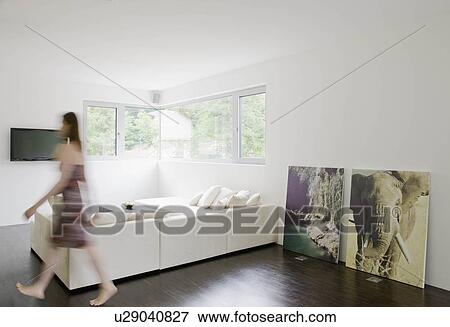 Stock Photo - Woman walking across living room. Fotosearch