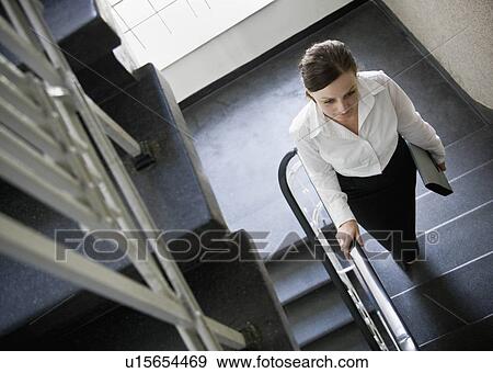 Stock Photo - Woman walking up stairs. Fotosearch