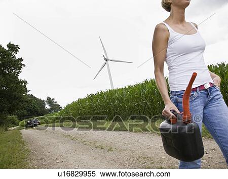 Woman walking with a gas can View Large Photo Image Stock Photography - Woman walking with a gas can. Fotosearch