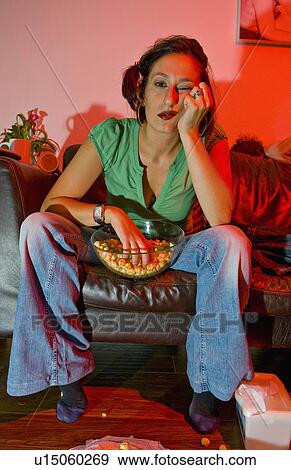 Stock Photo - Woman watching a film.. Fotosearch