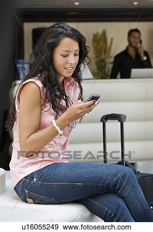 Woman with luggage and cellular phone View Large Photo Image Stock Photo - Woman with luggage and cellular phone. Fotosearch