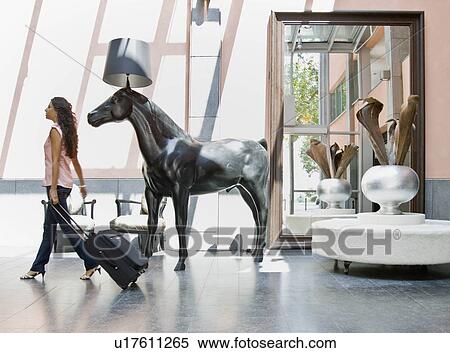 Woman with luggage in a lobby View Large Photo Image Stock Photography - Woman with luggage in a lobby. Fotosearch