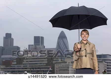 Woman with umbrella city scape View Large Photo Image Stock Image - Woman with umbrella city scape. Fotosearch