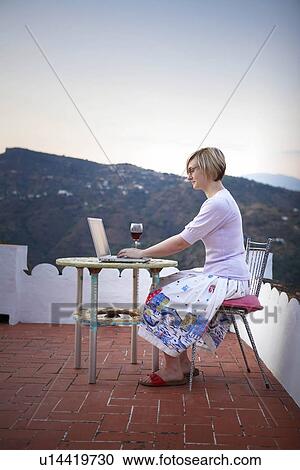 Stock Image - Woman working on a laptop. Fotosearch