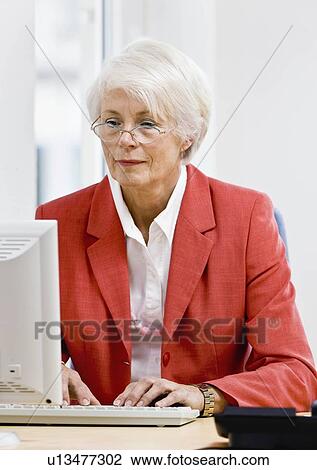 Woman working on computer View Large Photo Image Stock Image - Woman working on computer. Fotosearch