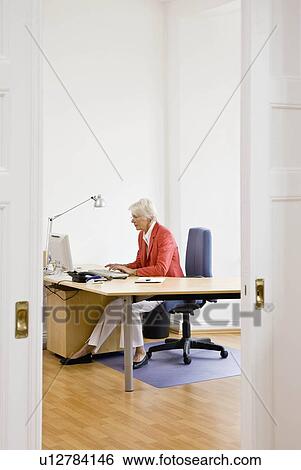 Woman working on computer View Large Photo Image Stock Photograph - Woman working on computer. Fotosearch