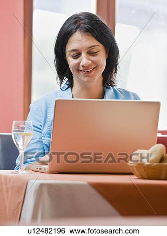 Stock Photograph - Woman working on laptop computer. Fotosearch