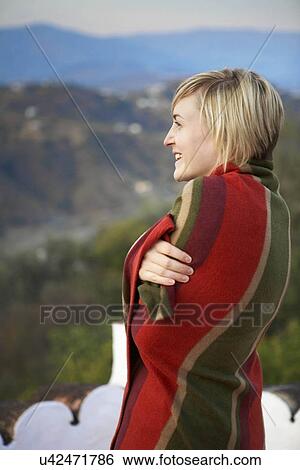 Stock Photograph - Woman wrapped in a blanket. Fotosearch