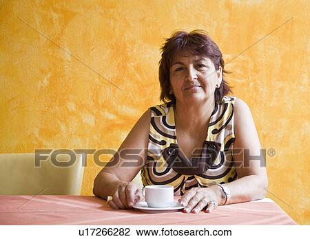 Women enjoying a cup of coffee View Large Photo Image Stock Image - Women enjoying a cup of coffee. Fotosearch
