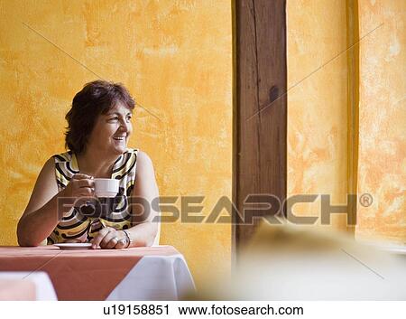 Women enjoying a cup of coffee View Large Photo Image Stock Image - Women enjoying a cup of coffee. Fotosearch