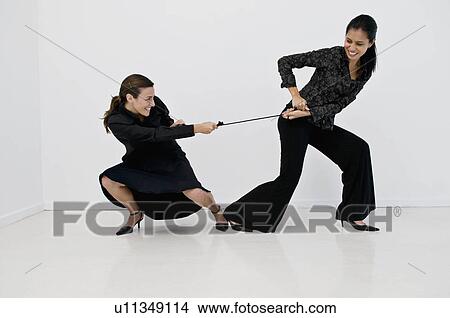 Women having a tug of war View Large Photo Image Picture - Women having a tug of war. Fotosearch