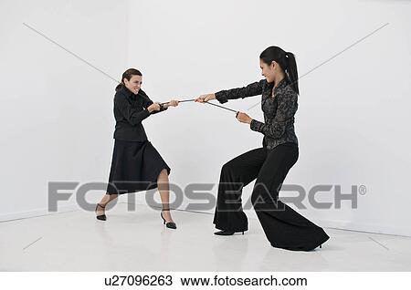 Women having a tug of war View Large Photo Image Stock Image - Women having a tug of war. Fotosearch