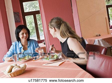 Stock Photography - Women talking over a meal. Fotosearch