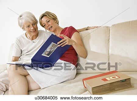 Women talking over photos View Large Photo Image Stock Photography - Women talking over photos. Fotosearch