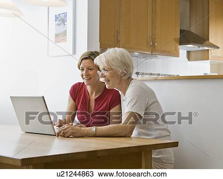 Stock Image - Women working on computer. Fotosearch