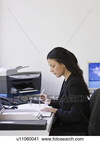 Worker in busy office View Large Photo Image Stock Image - Worker in busy office. Fotosearch