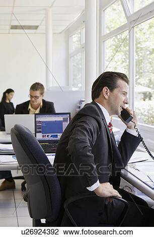 Workers in busy office View Large Photo Image Stock Image - Workers in busy office. Fotosearch