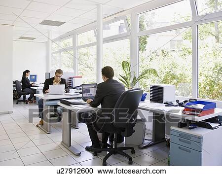 Workers in busy office View Large Photo Image Stock Image - Workers in busy office. Fotosearch