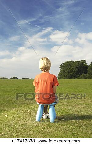 Stock Photo - young blond boy on stool. Fotosearch