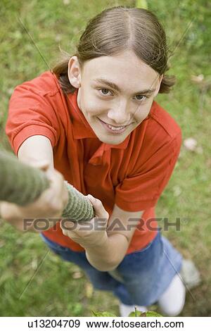 Young boy climbing on a tree rope View Large Photo Image Stock Photo - Young boy climbing on a tree rope. Fotosearch