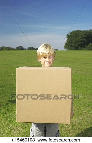 Stock Photo - young boy holding box to camera. Fotosearch