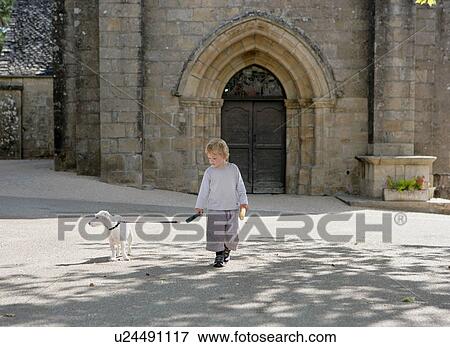 Young boy walking dog View Large Photo Image Stock Photo - Young boy walking dog. Fotosearch