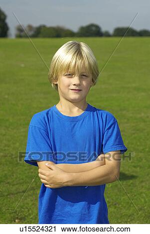 Stock Image - young boy with arms folded. Fotosearch