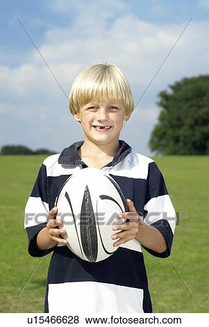 young boy with rugby ball View Large Photo Image Stock Photo - young boy with rugby ball. Fotosearch