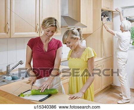 Young girl and women preparing meal View Large Photo Image Stock Photograph - Young girl and women preparing meal. Fotosearch