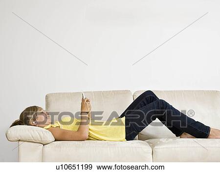 Stock Photo - Young girl listening to mp3 player. Fotosearch
