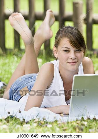 Stock Photo - Young girl playing on a computer. Fotosearch