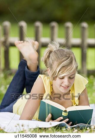 Young girl reading a book View Large Photo Image Stock Photo - Young girl reading a book. Fotosearch