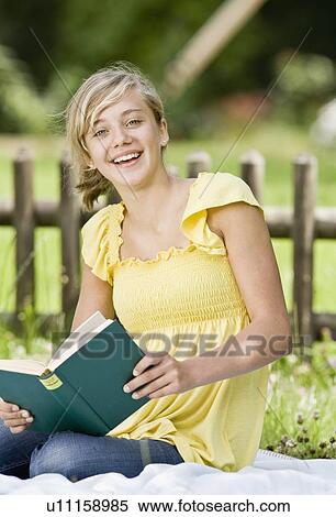Young girl reading a book View Large Photo Image Stock Photography - Young girl reading a book. Fotosearch