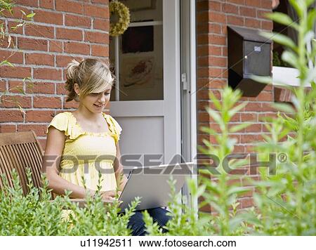 Young girl working on a laptop computer View Large Photo Image Stock Image - Young girl working on a laptop computer. Fotosearch