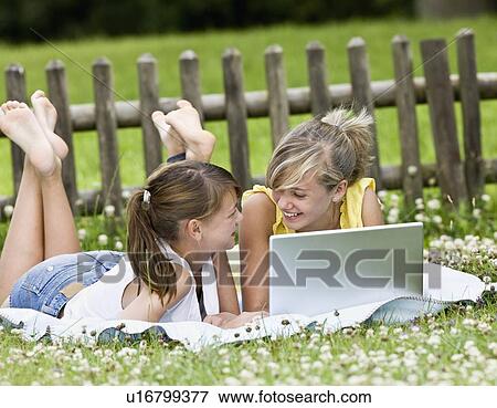 Young girls playing on a computer View Large Photo Image Stock Photo - Young girls playing on a computer. Fotosearch