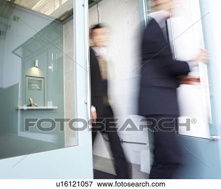Businesswoman and Businessman Walking Through Door View Large Photo Image Stock Photo - Businesswoman and Businessman Walking Through Door. Fotosearch