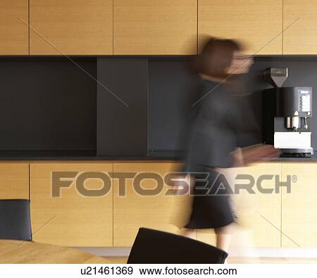 Mid-Adult Businesswoman walking in Kitchen View Large Photo Image Stock Photo - Mid-Adult Businesswoman walking in Kitchen . Fotosearch