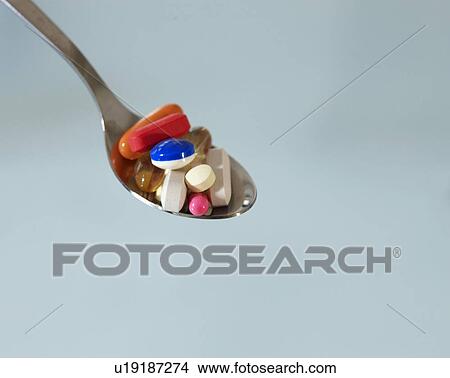Picture - Pills on Spoon. Fotosearch