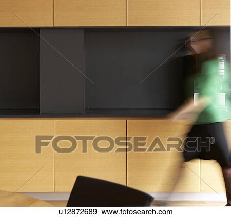 Stock Photo - Woman Walking in Kitchen. Fotosearch