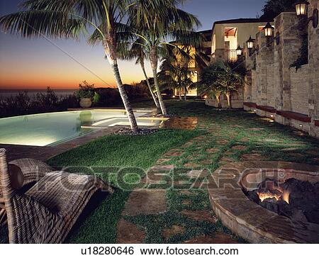 Backyard of modern home with pool at sunset View Large Photo Image Stock Photograph - Backyard of modern home with pool at sunset. Fotosearch