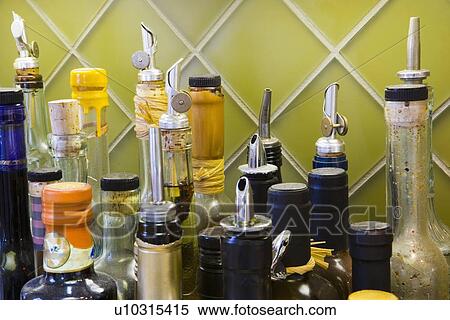 Stock Photography - Collection of bottles in kitchen. Fotosearch