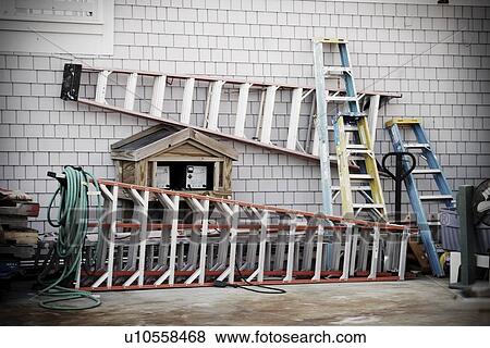 Collection of ladders along side of house View Large Photo Image Stock Photo - Collection of ladders along side of house. Fotosearch